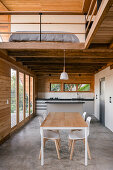 Wood-paneled house with gallery and open-plan kitchen-dining room