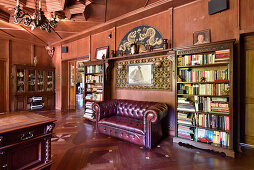 Traditional library with Chesterfield sofa and Chinese wall decor