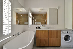 Modern bathroom with free-standing bathtub, washbasin and washing machine