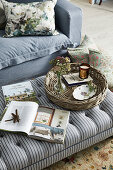 Striped upholstered stool with books and rattan tray in the living room