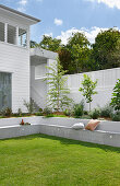 Garden with seating wall and fresh plants