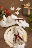 Christmas table decoration with ceramic stars and gift