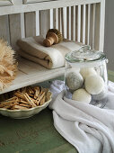 Storage jar with dryer balls, wooden clothes pegs, wooden brush and linen cloth