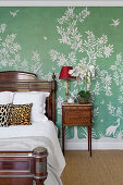 Antique bedroom with green wallpaper and floral patterns