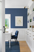 Desk in the study with blue accent wall and carpet