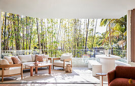 Modern terrace with wooden furniture and bamboo planting