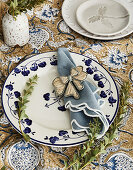 Table setting with floral porcelain plate and embroidered napkin