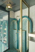 Shower with fish scale tiles and golden accents