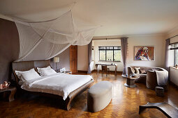 Spacious bedroom with canopy and parquet flooring