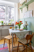 Cosy dining area with tulips and vintage decor in the kitchen window