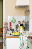 1940s kitchen with green teakettle and kitchen accessories