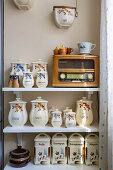 Shelf with vintage ceramic pots and retro-style radio