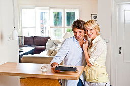 Young couple with an Ipad in a comfortabe atmosphere at home, Hamburg, Germany