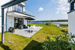Terrace with water view in a modern architecture style villa, Brandenburg, Germany