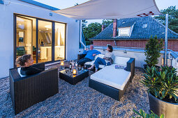 people on a roof terrace of a modern sigle-family house in Hamburg, north Germany, Germany