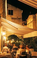 Terrace of a French restaurant in historic city setting at dusk