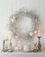 Christmas decorations with candles and a wreath on the wall