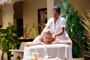 Blonde woman being massaged on holiday