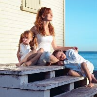 Mom and Two Daughters at the Beach Sitting on Stairs