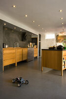 Modern kitchen with wooden units and built-in ceiling lighting