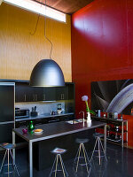 Modern kitchen with industrial lighting and contrasting colors