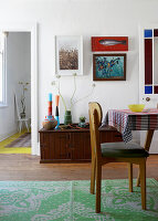 Dining area with vintage wooden furniture and green carpet