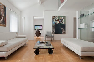 Spacious living room with modern furniture and artwork on the walls