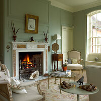 Classically furnished living room with fireplace and antique elements