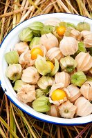 Cape gooseberries in bowl on straw