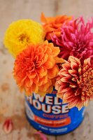 Bright, colourful bouquet of dahlias in old coffee can