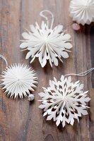 Christmas decorations: paper stars on a wooden surface