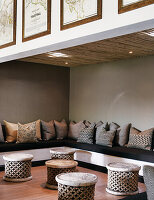 Lounge in earthy tones with African stools and corner bench with cushion collection