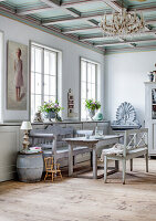 Country house dining room with wooden furniture and chandelier