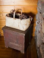 Pinecones are stored in a handmade basket made from birch tree bark