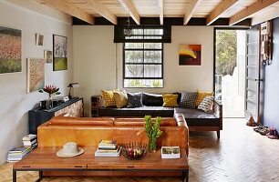 Living room with leather sofas and mid-century console