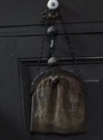 Vintage handbag hanging from drawer knob