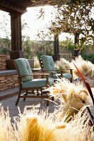 Armchairs and dried grass on patio
