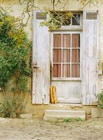 Baguettes leaning against rustic door; Aquitaine, France