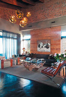 Living room with high ceiling, sculptural coffee table and leather chair