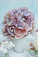 Elegant bouquet of silk flowers decorated with white pearl beads