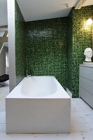 Modern free-standing bathtub in ensuite bathroom with green mosaic tiles