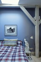 Blue wall and wooden beam structure in bedroom