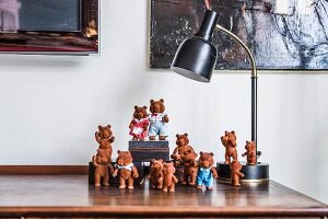 Collection of bear figurines under table lamp