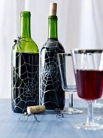Halloween wine bottles decorated with spiderwebs