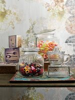Sweets in sweet jars and glass crockery on table