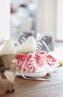 Pink booties next to other shoes