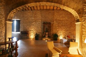 Stone walls and arched doorway in Mediterranean living room