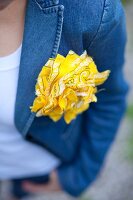 Yellow rosette made from bandana on denim jacket