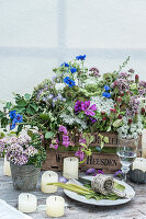 Lavish bouquet of wildflowers in wooden crate decorating table