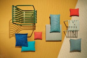 A garden chair and stool with decorative cushions made from UV and water-resistant fabrics